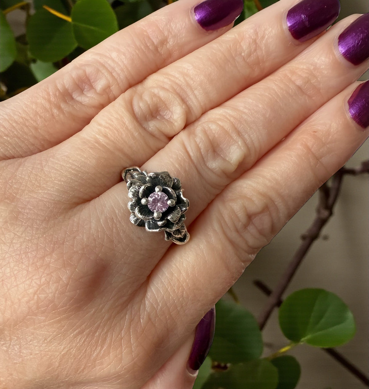rose flower ring with pink gemstone on hand