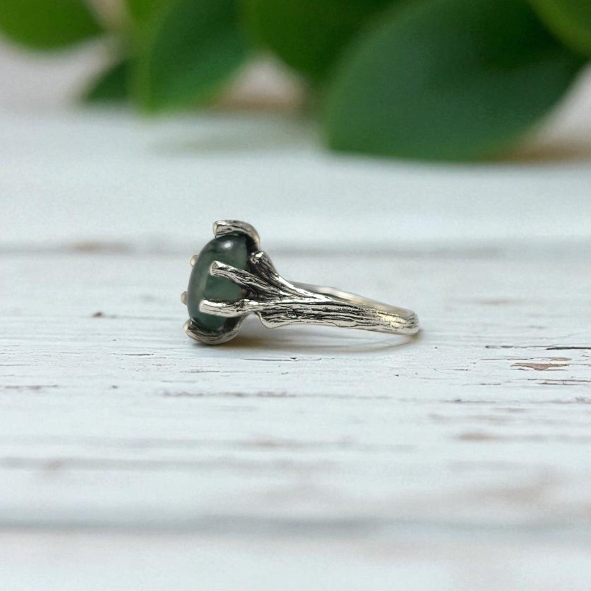 Sterling Silver ring with prongs holding an oval moss agate ring