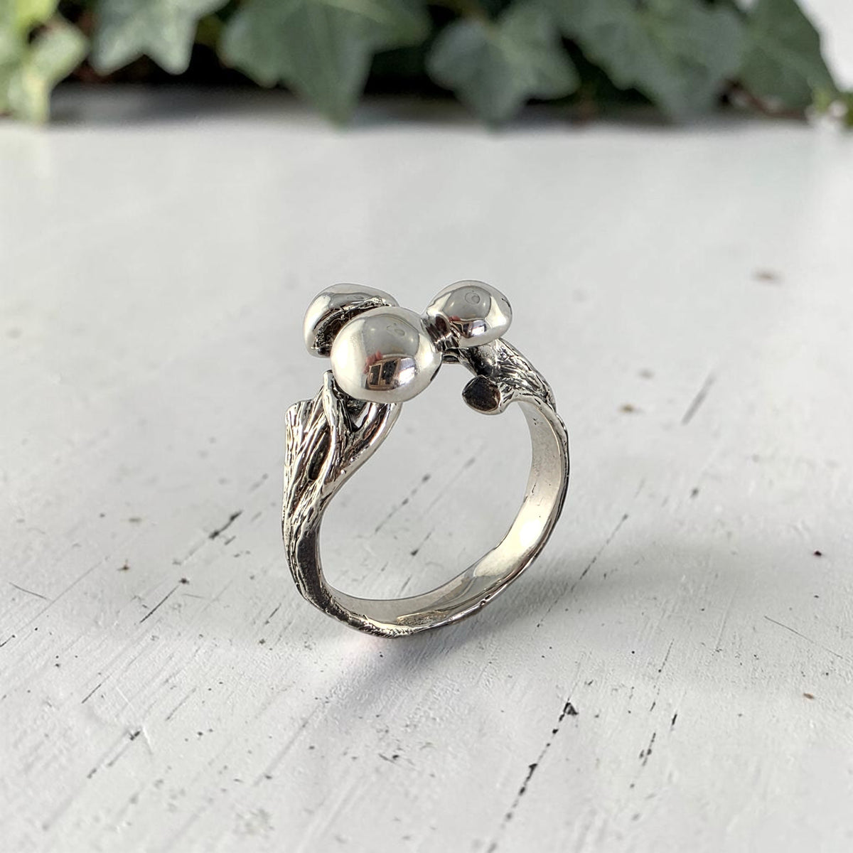 sterling silver ring with three mushrooms coming out of the top