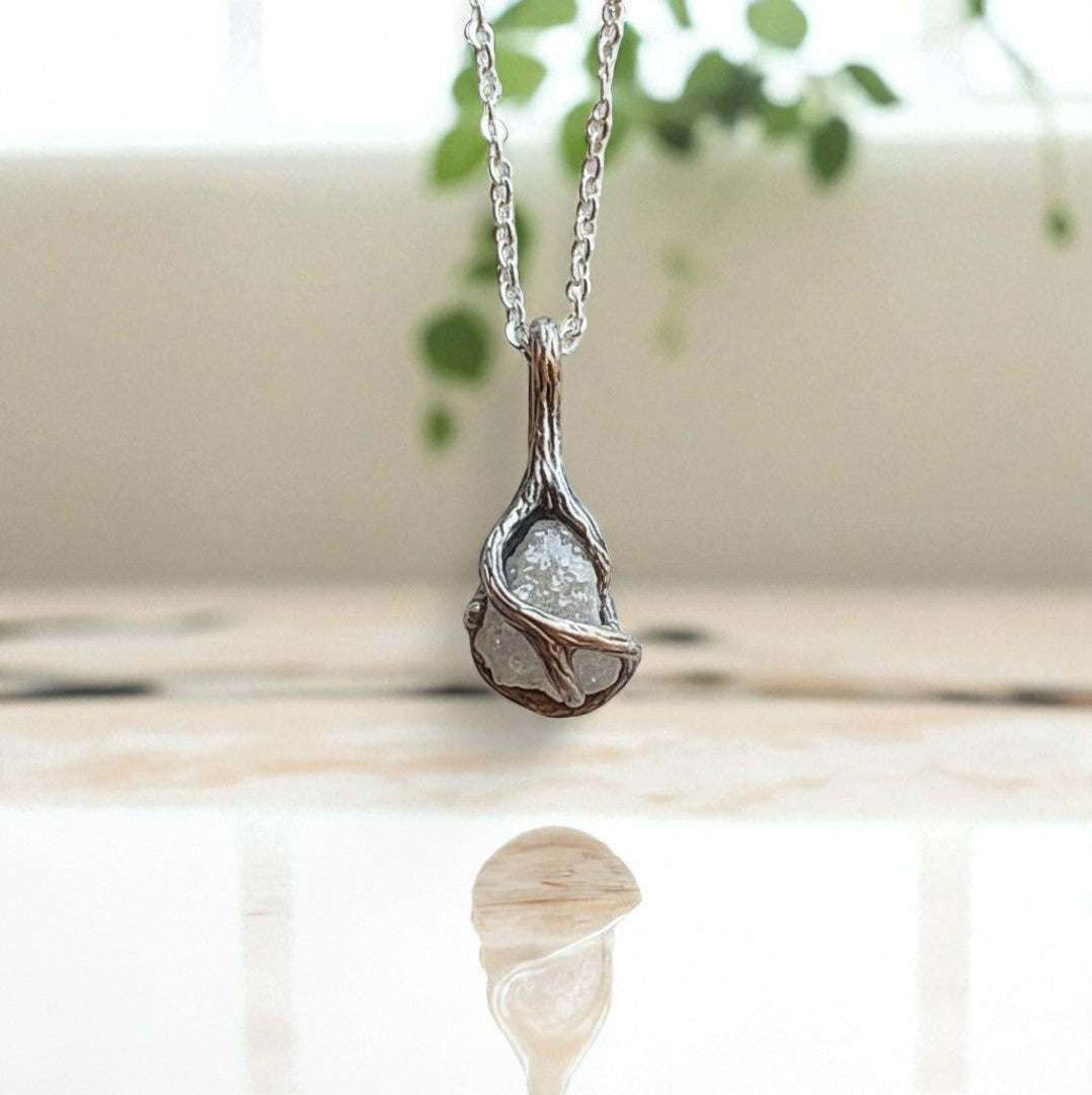 raw diamond necklace surrounded by twig style texture on a white gold chain