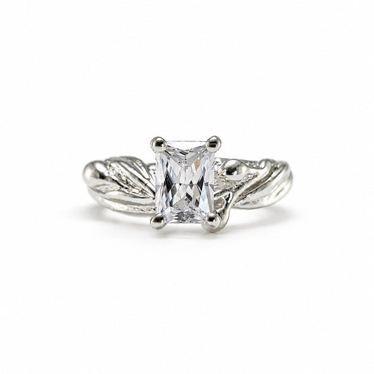 radiant cut moissanite diamond ring in a olive branch style ring setting